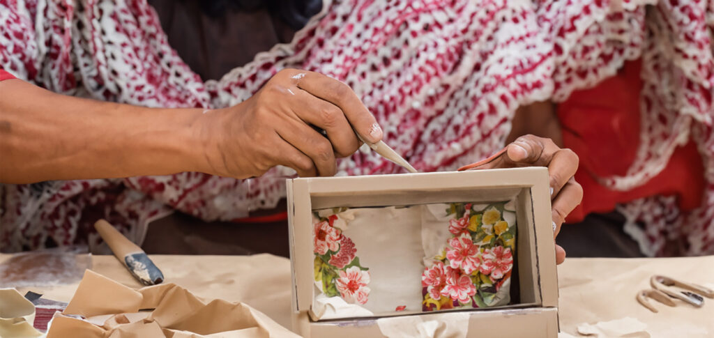 Kashmiri papier-mache artisan painting a piece by hand in a Srinagar workshop