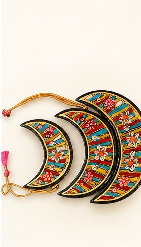 Set of three hand-painted papier mache crescent moon ornaments in multicolour with gold cord and pink tassel