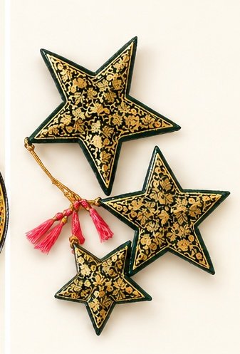 Set of three hand-painted papier mache star ornaments in gold and black with pink tassels