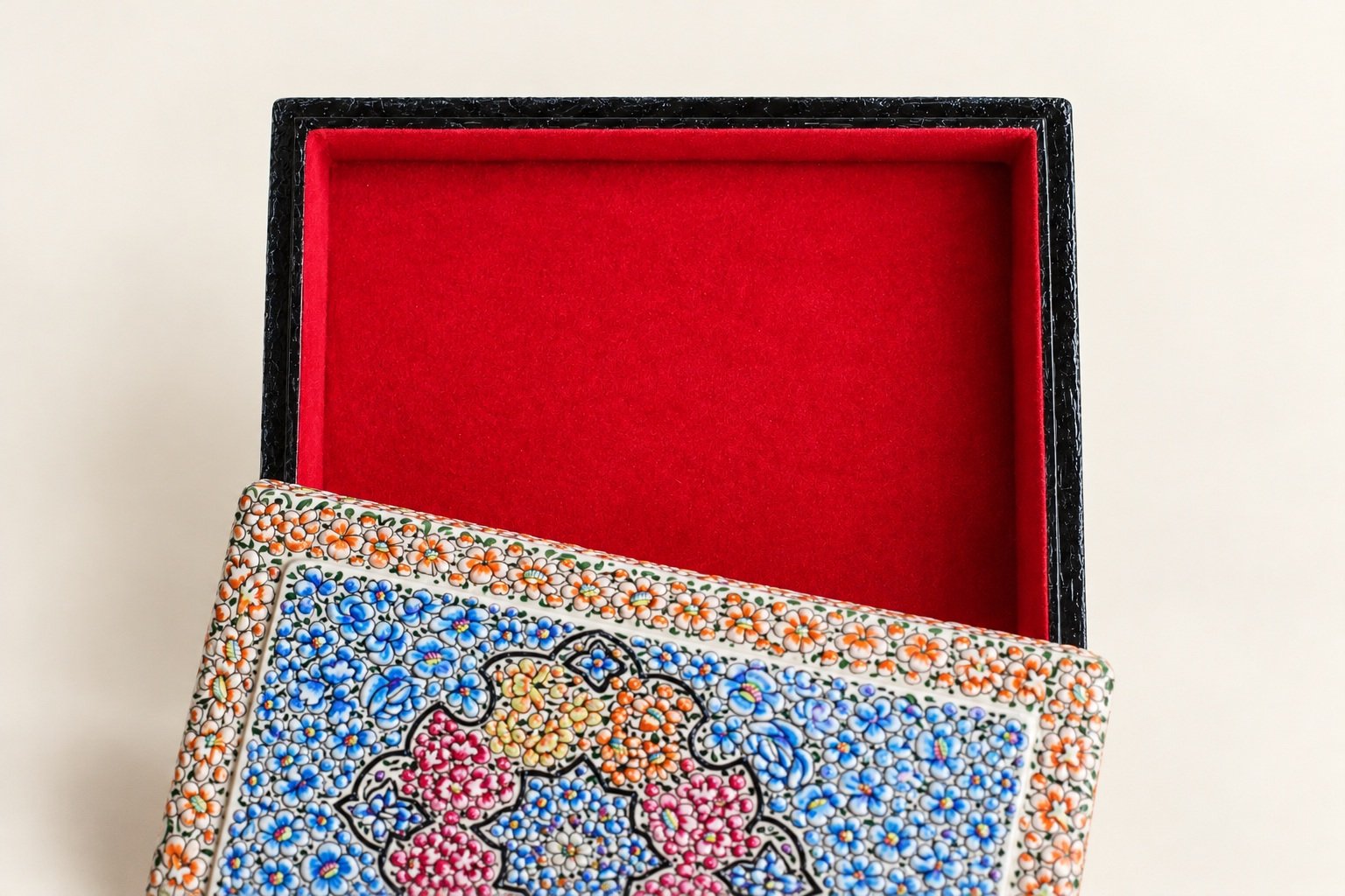 Blue and peach paper mache jewelry box with the lid off to show the red lining