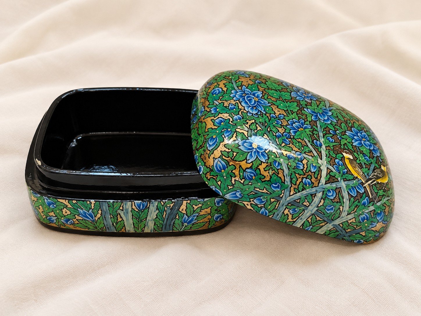 Open blue garden papier mache box with golden finches on the lid and glossy black lacquered interior