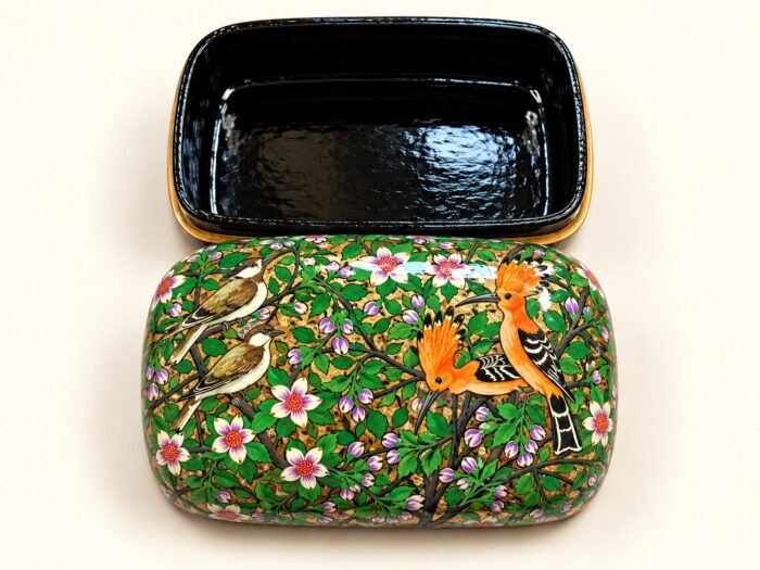 Open 7x4 inch papier mache box hand-painted with an orange crested bird and finches among white blossoms on green, glossy black lacquered interior