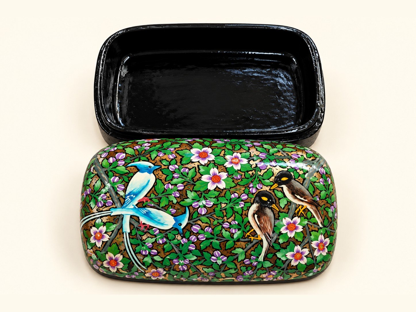 Open 7x4 inch papier mache box hand-painted with a blue dragonfly, songbirds and white flowers on green, glossy black lacquered interior