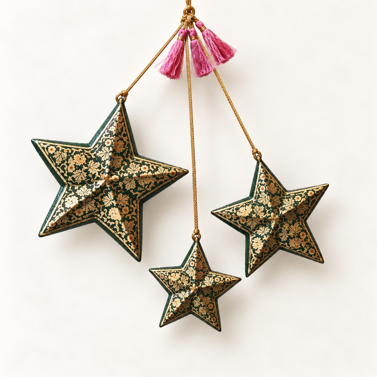 Gold and black papier mache star ornaments hand-painted in Kashmir with fine gold floral patterns on black
