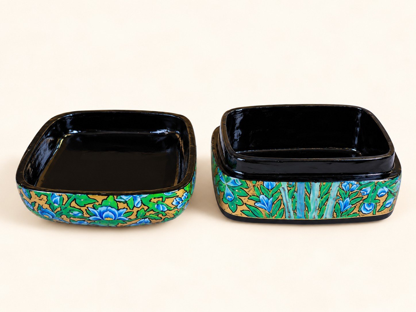 Goldfinch papier mache box opened to show the glossy black lacquered interior and blue floral hand-painted sides