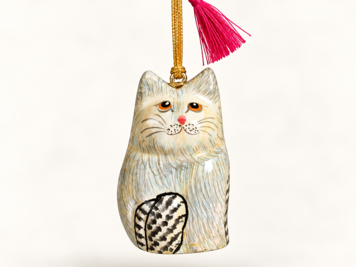 Hand-painted papier mache cream cat hanging ornament with pink tassel