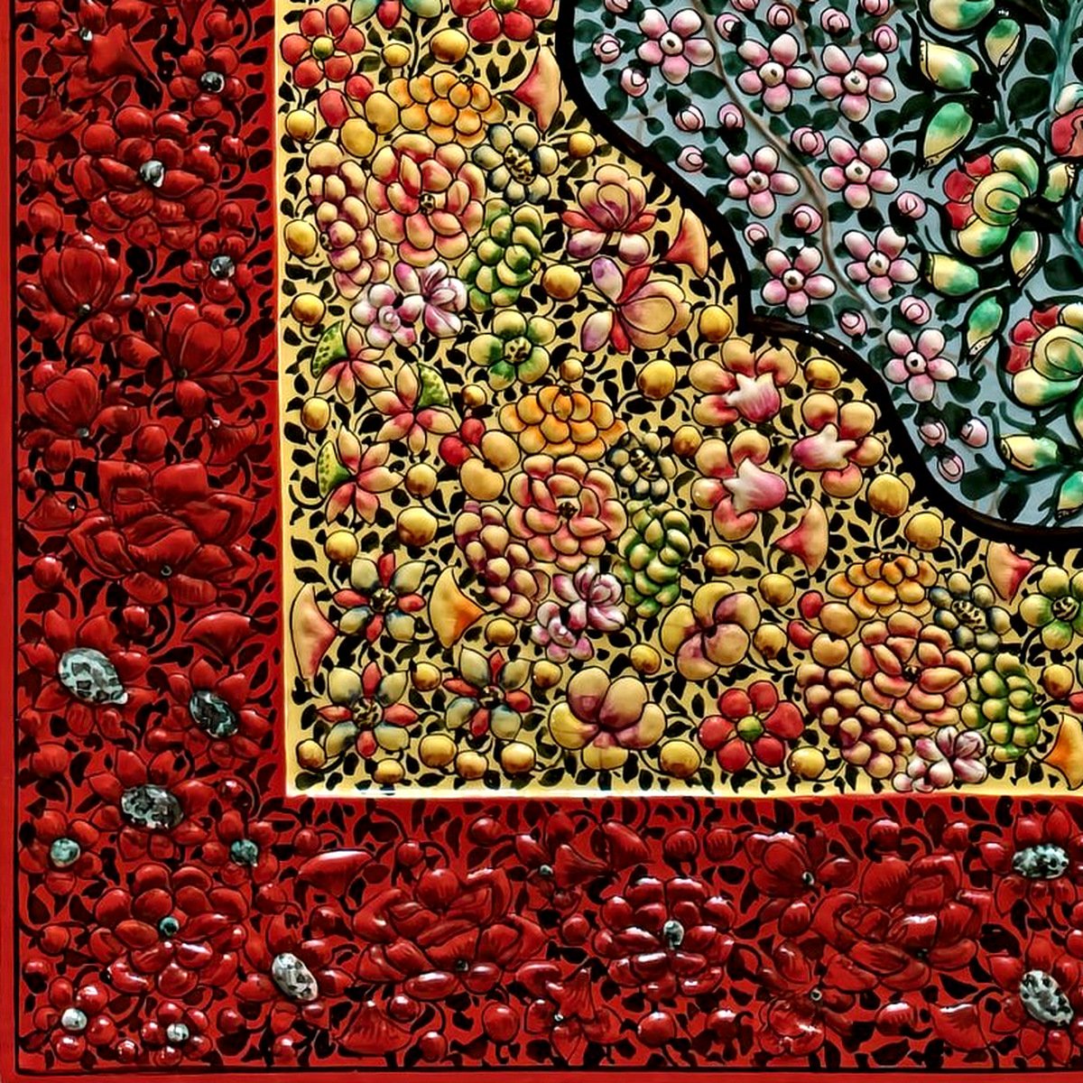 Macro of the raised hand-painted flowers on the red border