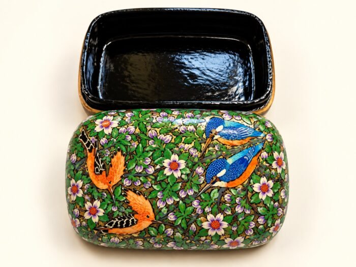 Open 7x4 inch papier mache box hand-painted with orange birds and a blue kingfisher among white blossoms on green, glossy black lacquered interior