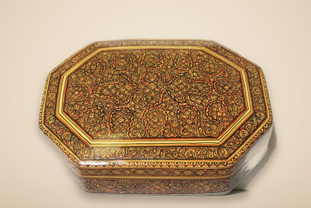 Paisley paper mache art style 3 – hand-painted Kashmiri paper mache art in a paisley Mughal design, style 3, on a warm studio background