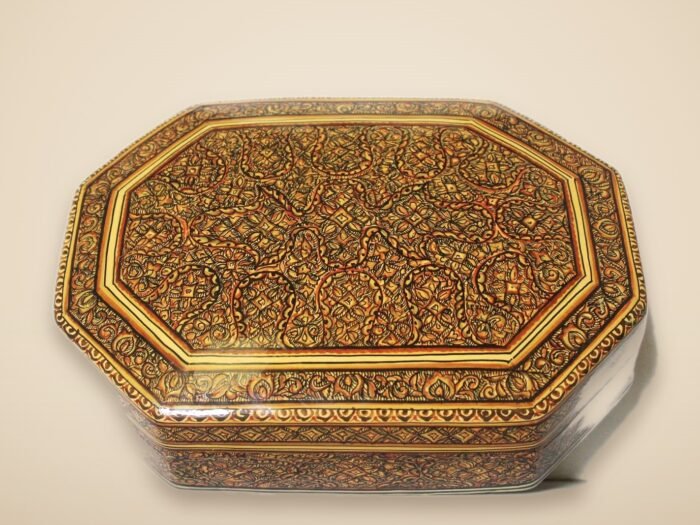 Hand-painted Kashmiri paper mache art in a paisley Mughal design, style 3, on a warm studio background