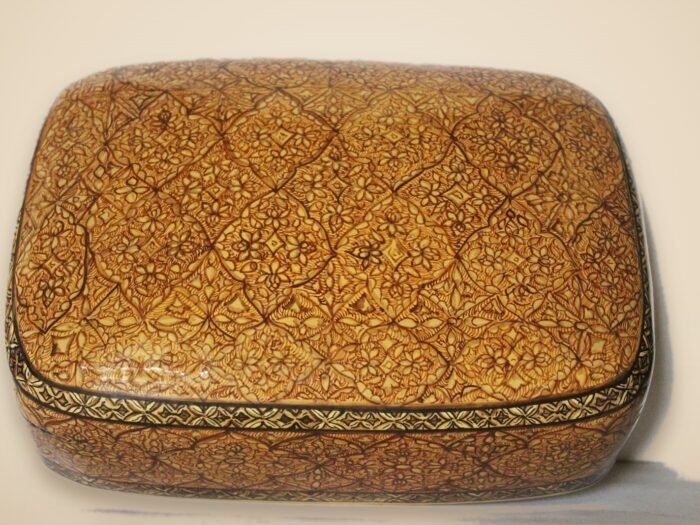 Hand-painted Kashmiri paper mache art in a paisley Mughal design, style 4, on a warm studio background