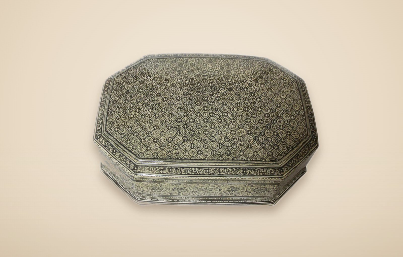 Hand-painted Kashmiri paper mache art in a paisley Mughal design, style 5, on a warm studio background