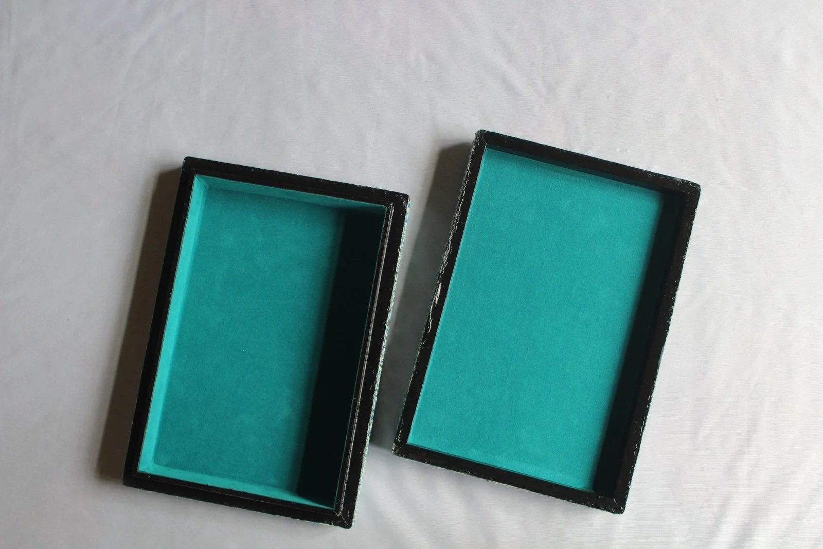 Blue floral paper mache trinket box open to show the teal lining