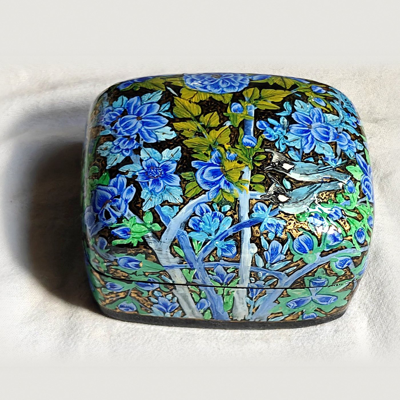 24K gold papier mache box, Blue Garden No. 6, hand-painted with two bulbuls in flight and real 24K gold strokes, with the lid on