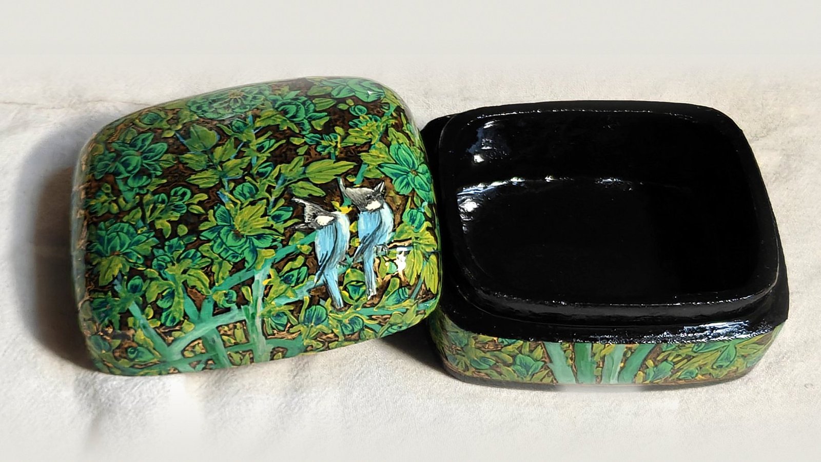 Emerald Garden papier mache box No. 2 hand-painted with a pair of crested bulbuls among emerald and leaf-green flowers, real 24K gold strokes in the background, with the lid off, showing the glossy black lacquered interior