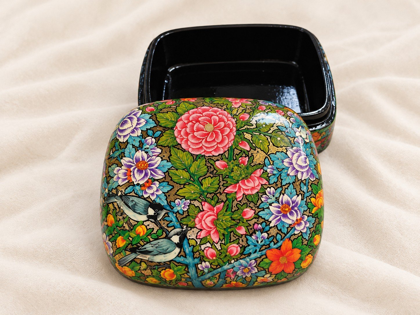 Open pink peony papier mache box beside its black lacquered base, lid hand-painted with pink peony and blue bird