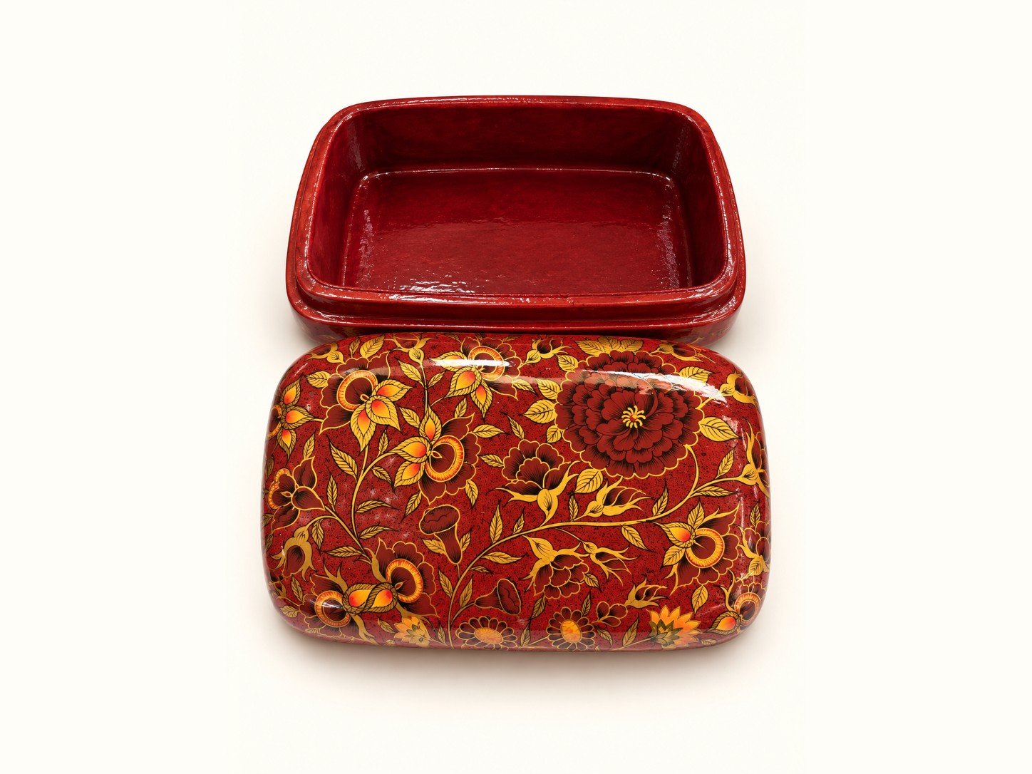 Red maroon papier mache box lid with golden floral vines beside its matching red lacquered base