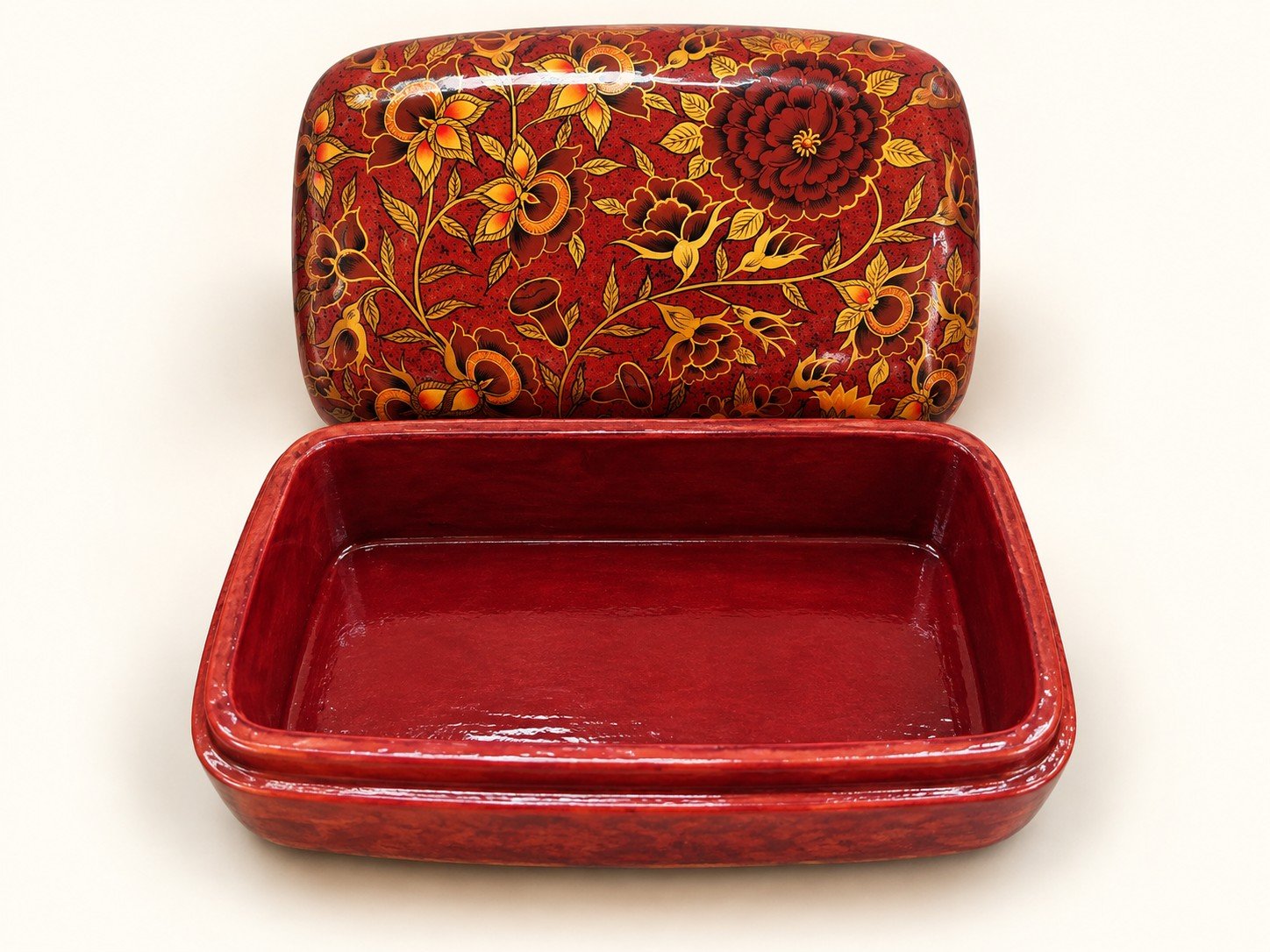 Open red maroon papier mache box hand-painted with golden floral vines and leaves, matching red interior