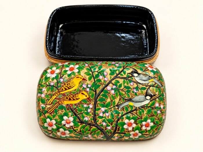 Open 7x4 inch papier mache box hand-painted with golden yellow birds on flowering branches and white blossoms, glossy black lacquered interior
